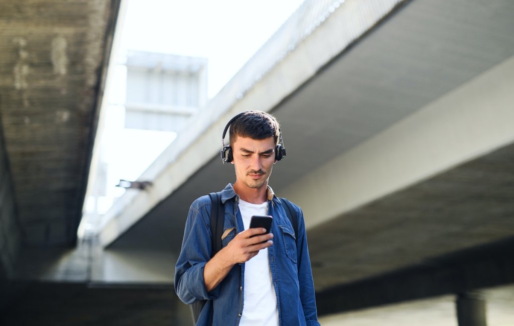 Some dude looking at X on his phone