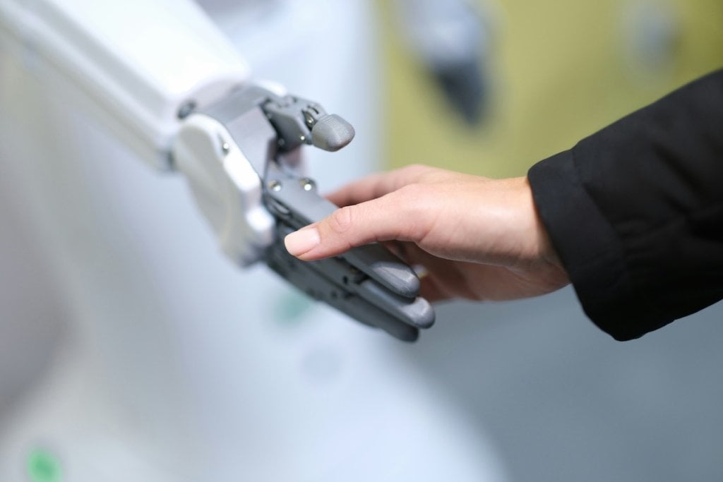A robot and a person holding hands