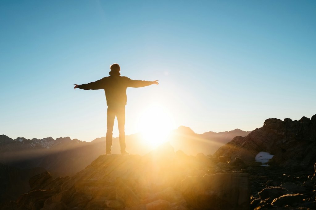 The silhouette of a man holding his arms out, representing freedom