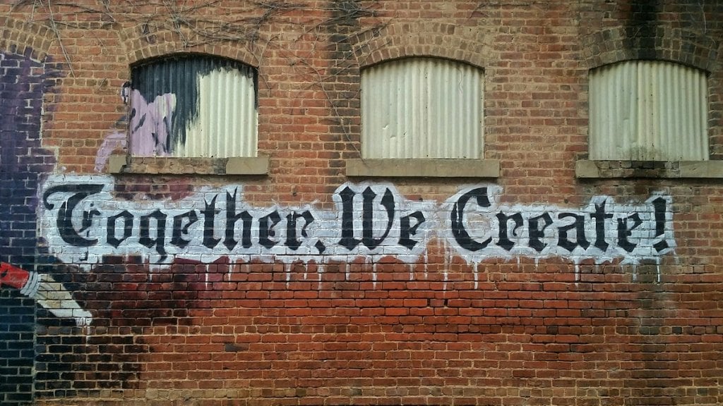 Street art that reads: together, we create!